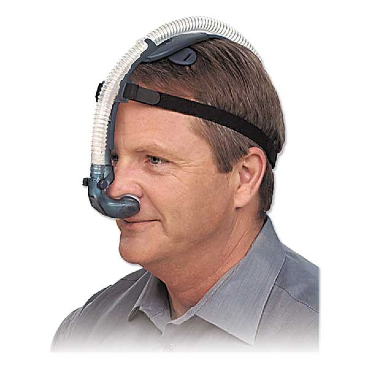 Stock photo of man wearing Puritan Bennett Breeze nasal pillow CPAP mask