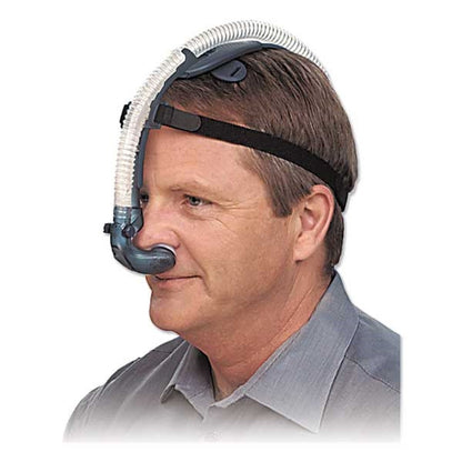 Stock photo of man wearing Puritan Bennett Breeze nasal pillow CPAP mask