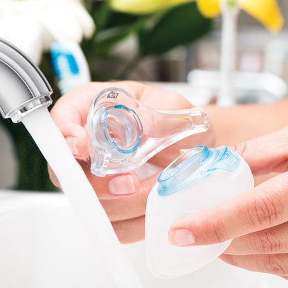 Photo of hands washing Fisher and Paykel Brevida nasal pillow CPAP mask cushion clip and seal