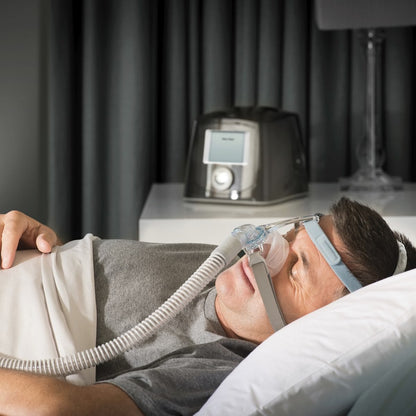 Photo of man using Fisher & Paykel Eson 2 nasal CPAP mask kit with headgear
