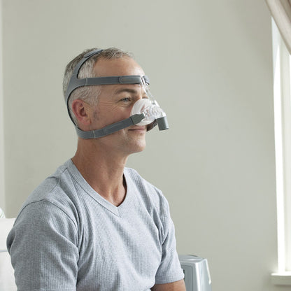 Photo of man wearing Fisher & Paykel Eson nasal CPAP mask with headgear
