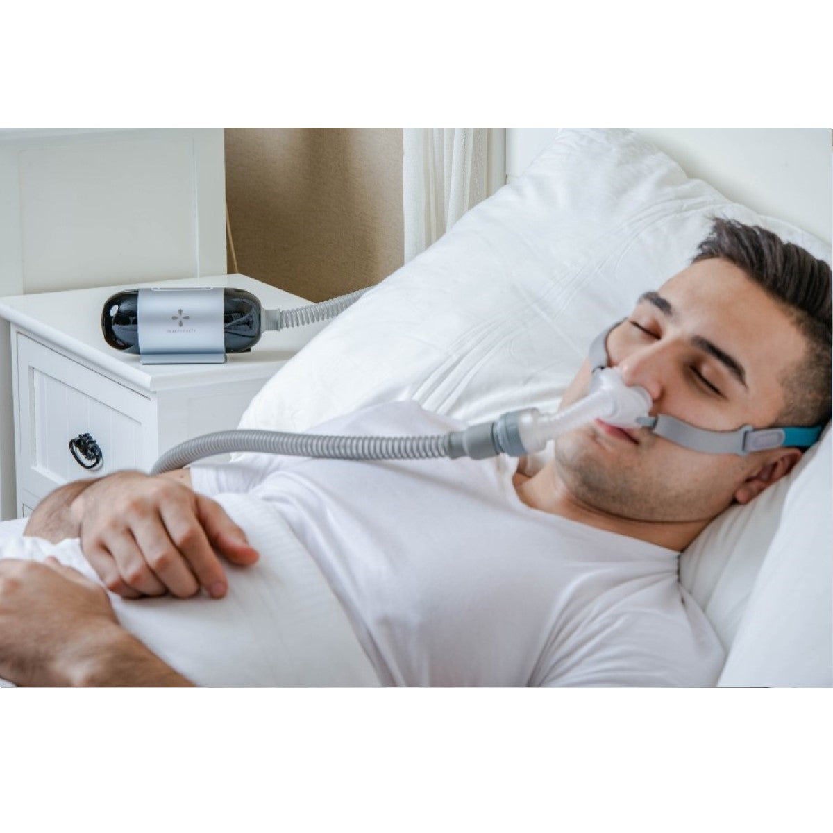 Photo of man using React Health Luna TravelPAP machine