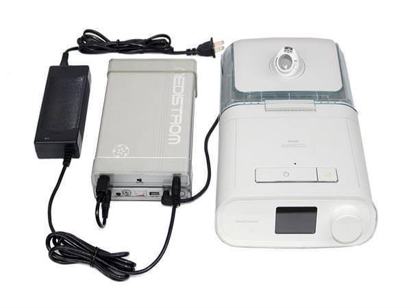 Stock photo of Choice One Medical Medistrom Co Pilot 12 CPAP machine battery add on plugged into CPAP machine