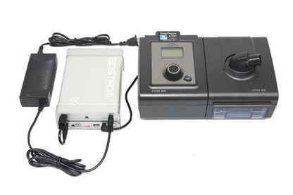 Stock photo of Choice One Medical Medistrom Co Pilot 12 CPAP machine battery add on unit plugged into CPAP machine