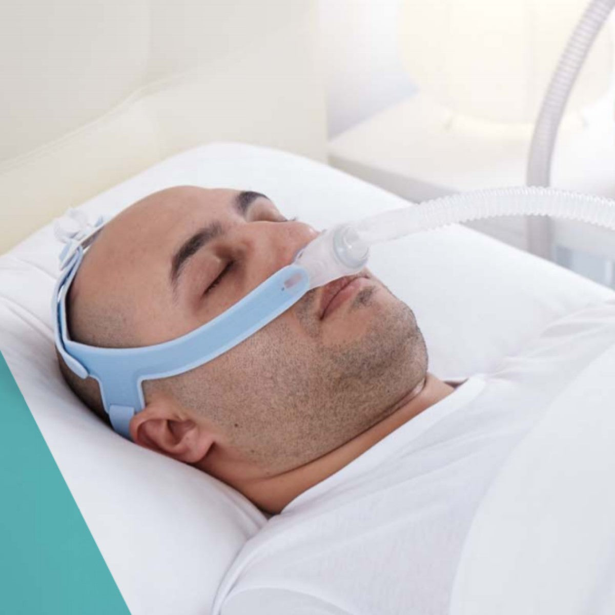 Stock Image of Man Sleeping Supine Wearing Ms. Wizard 230 Nasal Pillow CPAP Mask W/ Headgear by Apex Medical