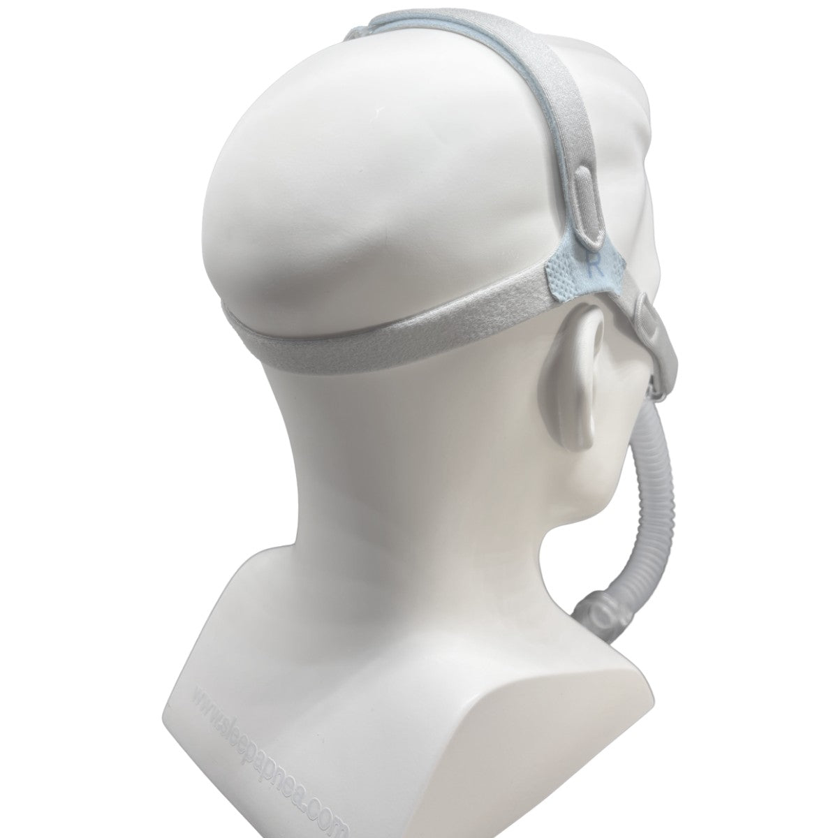A sleep apnea mask with a light gray headband and tube, shown on a white mannequin head from a side-back angle against a white background.