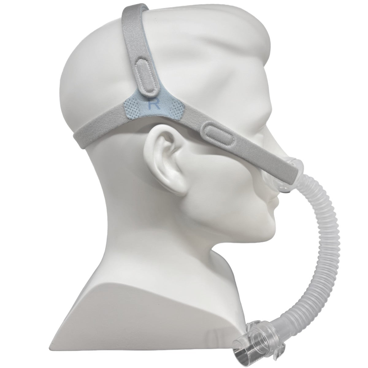 A side-profile view of a white mannequin head wearing a Nefes CPAP mask.