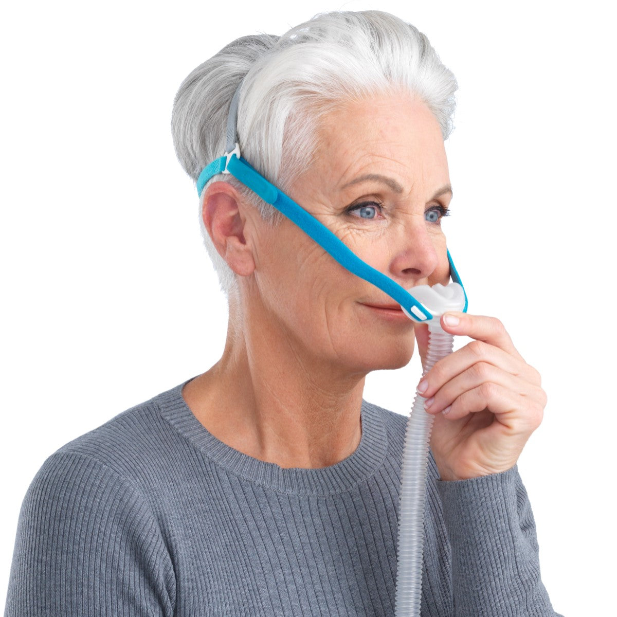 Stock photo of woman wearing Fisher & Paykel Nova Micro nasal pillow CPAP mask with headgear