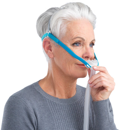 Stock photo of woman wearing Fisher & Paykel Nova Micro nasal pillow CPAP mask with headgear
