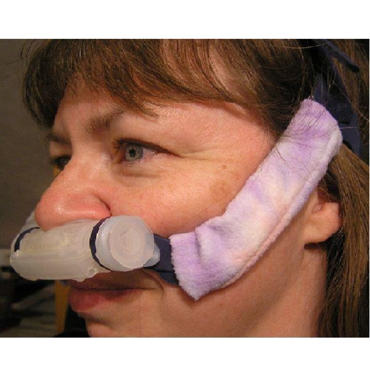 Photo of a woman wearing Pad-A-Cheek Strap Pad For Mirage Swift II