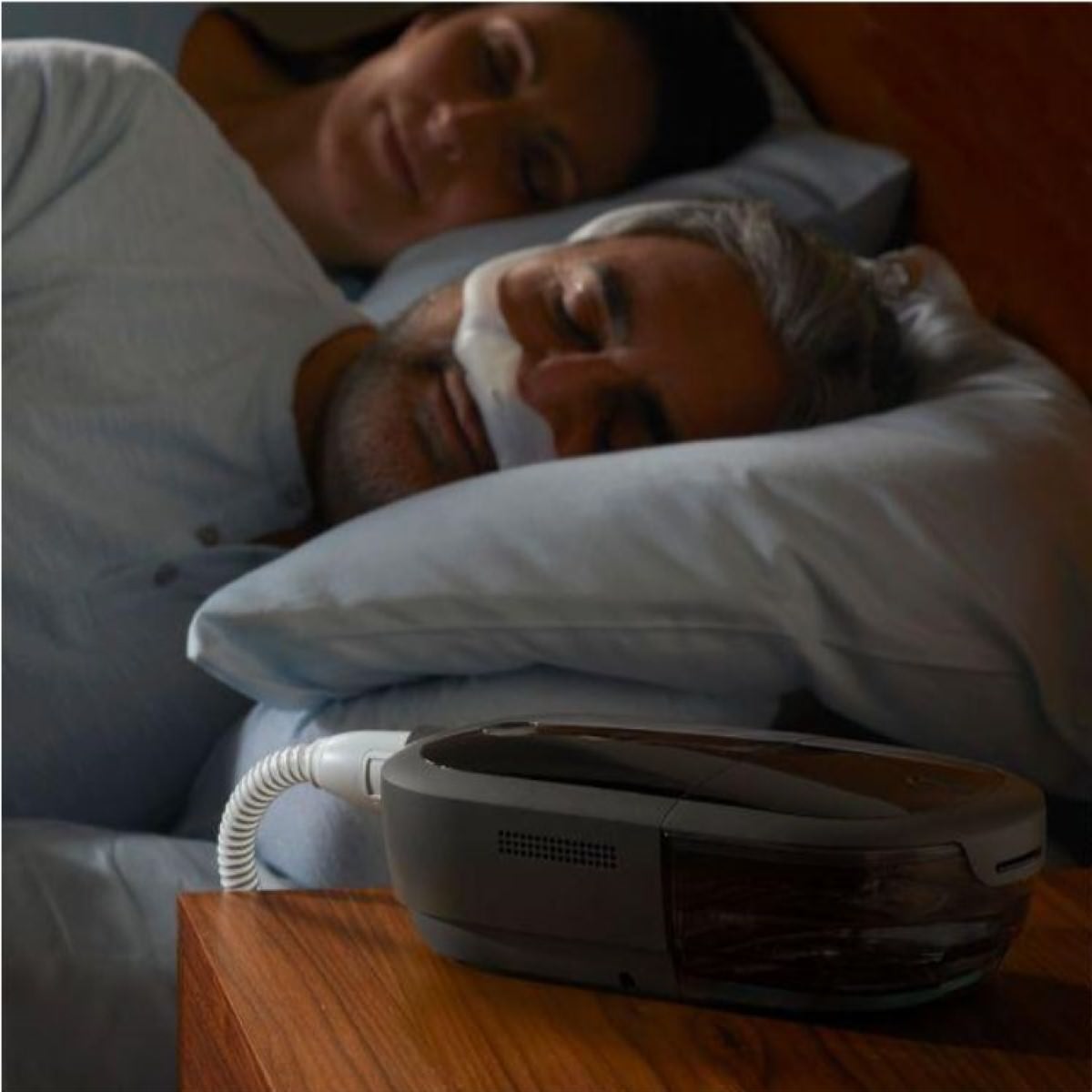 Photo of a man using Philips Respironics DreamStation 2 Auto CPAP machine