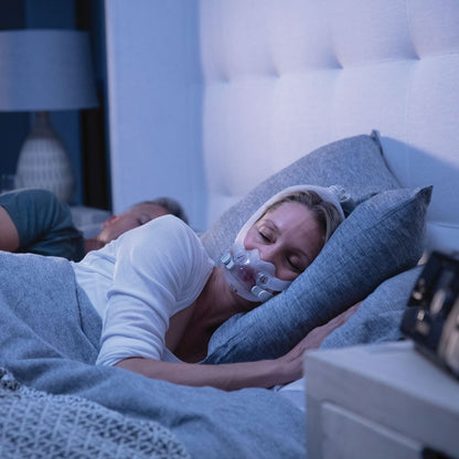 Photo of woman sleeping while wearing ResMed AirFit F30i full face CPAP mask kit