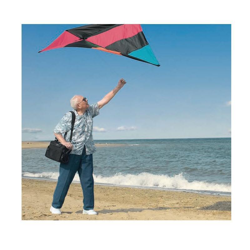 Photo of man flying a kite while holding a Philips Respironics EverGo Portable Oxygen concentrator