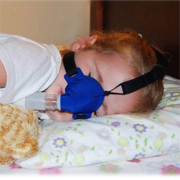 Child Sleeping on Her Side Using SleepWeaver Advance Pediatric Soft Cloth Nasal CPAP Mask W/ Headgear 