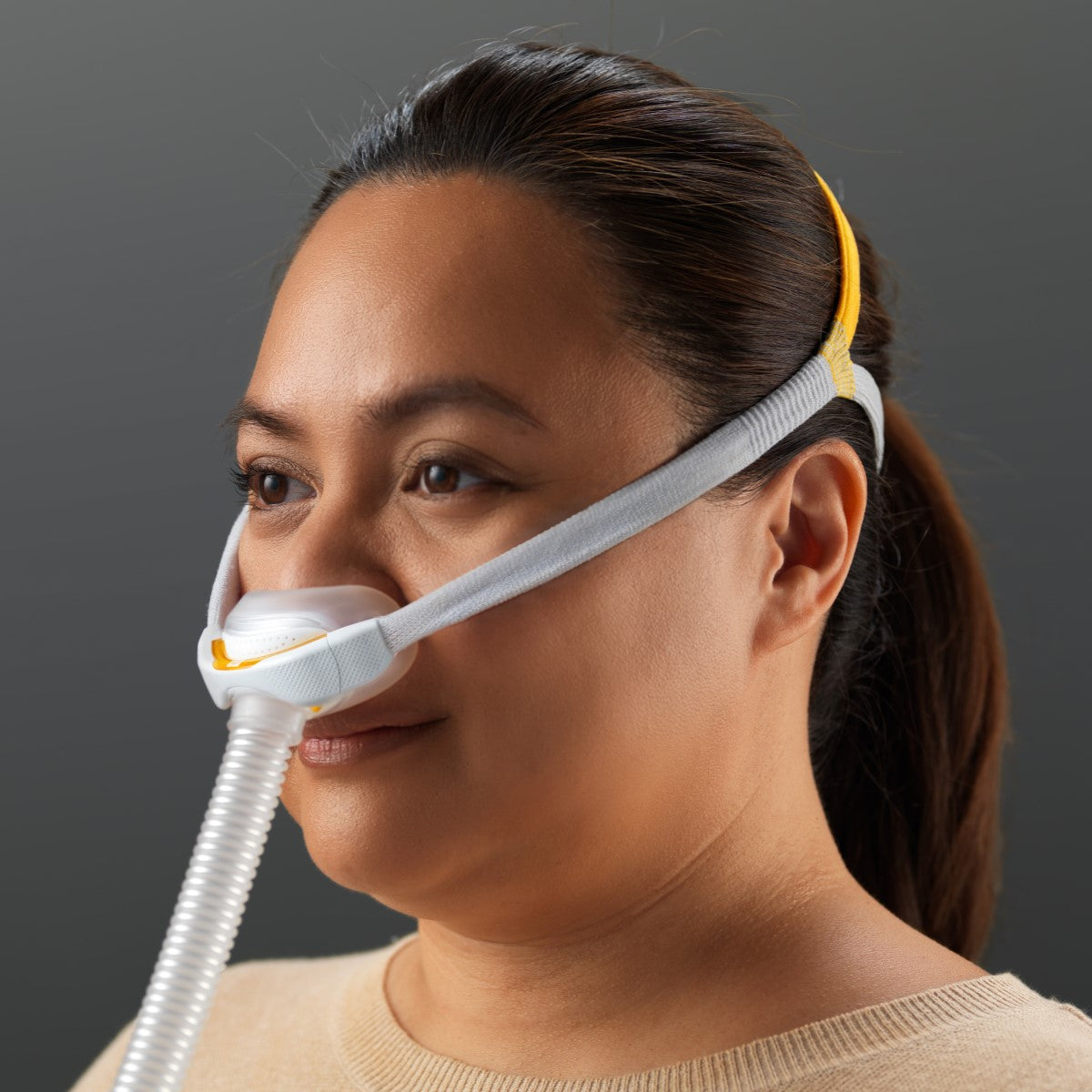 Stock Image of Woman Wearing Fisher & Paykel's Solo Nasal CPAP Mask W/ Headgear 