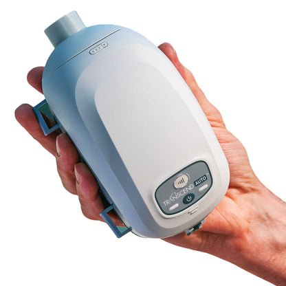Stock photo of hand holding Somnetics Transcend Mini Auto CPAP With EZEX CPAP machine