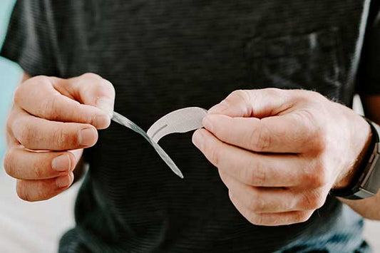 Stock Image of Man Peeling Back the Adhesive Plastic of His Somnifix Mouth Strips