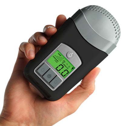 Stock photo of a hand holding a Breas Z1 Auto Adjusting travel CPAP machine